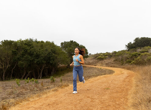 Asian fitness athlete  running outdoors alone