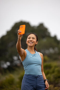Asian fitness athlete  smile selfie cell phone Portrait 