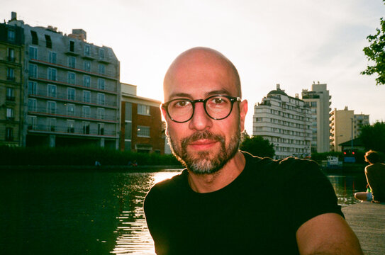 Man Sitting by river at Urban Location