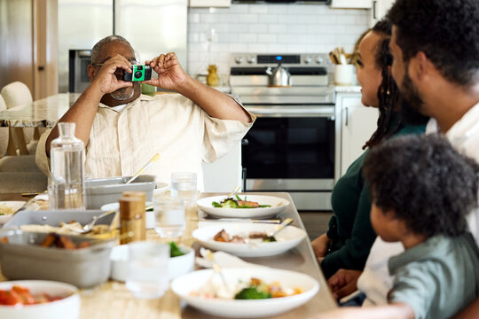 Family Shares Meal at Kitchen Table