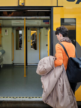Woman boarding public transport train in Oporto
