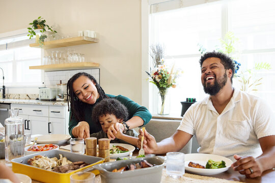 Couple an their son Enjoys Meal at home