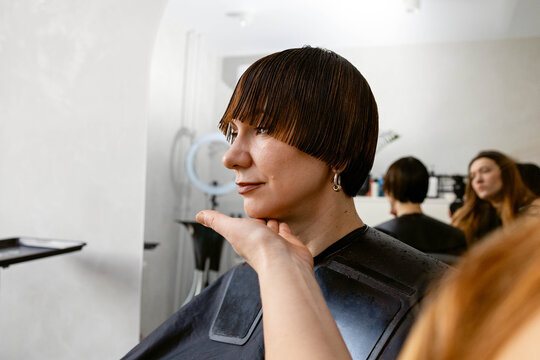 Woman getting a haircut in a salon setting