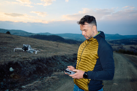 Man operates drone using remote