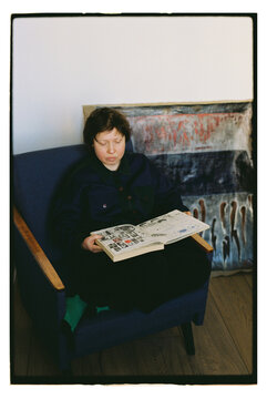 A woman looks at her sketches