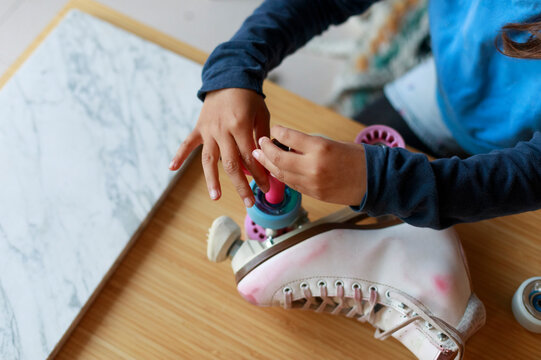 Child Fixing Roller Skate Wheels 