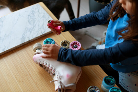 Child Replaces Wheels on Roller Skates 