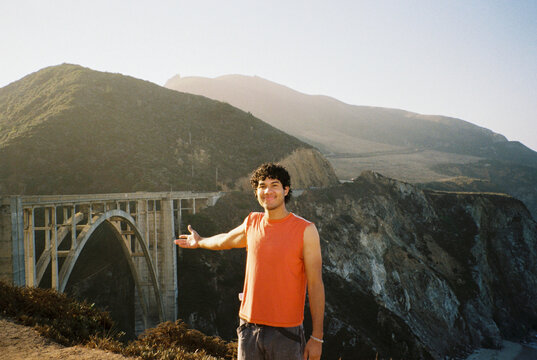 Man Poses Near Bixby Bridge on Coastal Highway in Big Sur