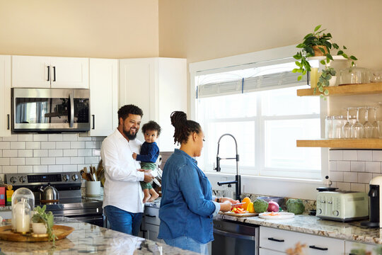 Family Cooking Together in Their Home Kitchen