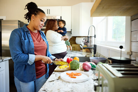 Family Cooks Together in Home Kitchen During Day