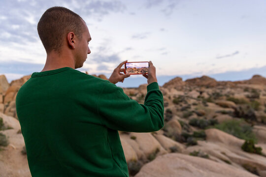 Tourist take photo mobile phone Joshua Tree Landscape 