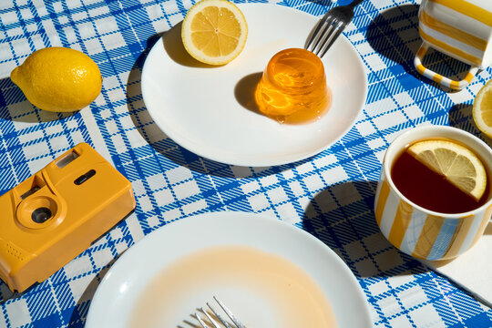 Summer picnic still life. Lemon tea, jelly dessert and retro camera.