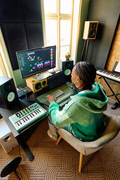 Black Music Producer Working in Professional Home Studio Environment