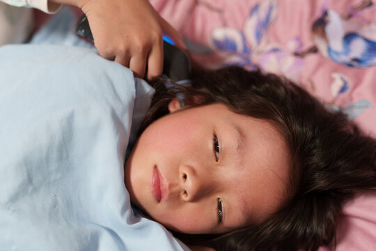 Ear Thermometer Measuring Feverish Girl Temperature