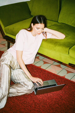 Business Woman Using Laptop in Office with Flash