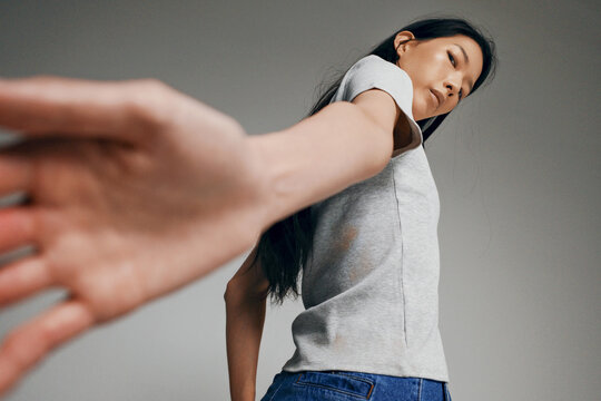 Person reaching out with hand in a fashion pose