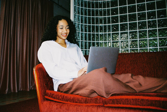 Business woman using laptop in office with flash film photo