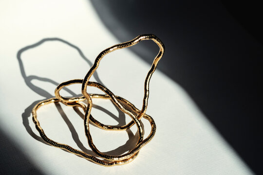Gold Wire Sculpture on Table With Shadows in Afternoon Light