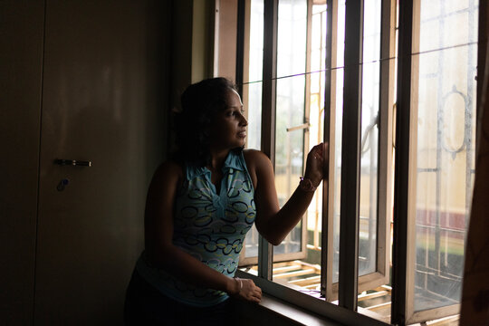 Indian woman looking beyond the window 