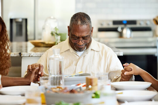 Family Prays in Kitchen Before Meal
