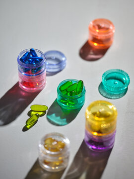 Colorful capsules in small containers, a vibrant display of health
