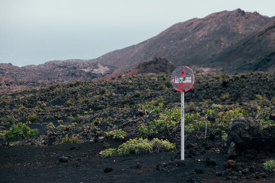 Volcanic lava field with warning sign on La Palma island