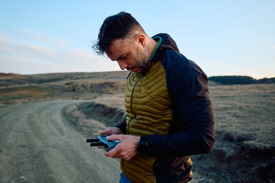 Man operates his drone using remote control