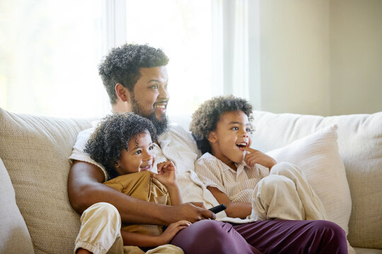 Father and Children Enjoy Time Together watching TV