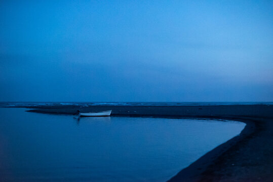 Small boat on a quiet shore at dusk