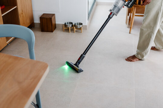 Anonymous man balances remote work with household tasks
