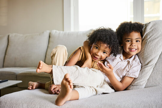 Kids Playing Together on a Couch in a Home