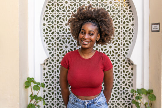 Portrait of a young black woman with afro hair and braces