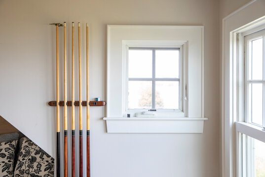 Stick Pool billiard Cue on rack in Playroom 