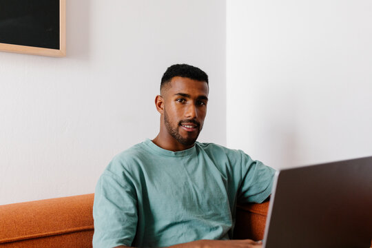 Black entrepreneur looking at the camera, enjoying a productive day