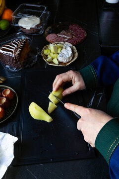 A woman is cutting food.