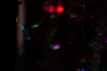 Fototapeta premium Abstract Dark Background with Colorful Bokeh Lights and Shimmering Particles
