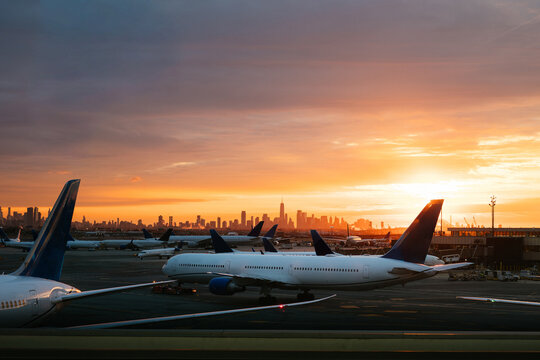 Sunrise at Airport With Planes and  NYC Skyline in Background