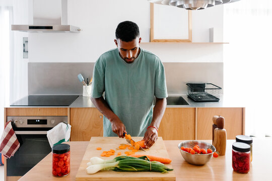 Man juggling remote work from home with household
