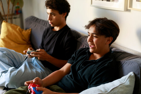 Teen boy laughing while gaming