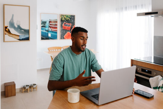 Black man who owns an online business taking a business video call