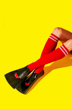 the crossed legs of a man in red socks wear diving fins