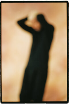 Person in black clothing with blurred effect