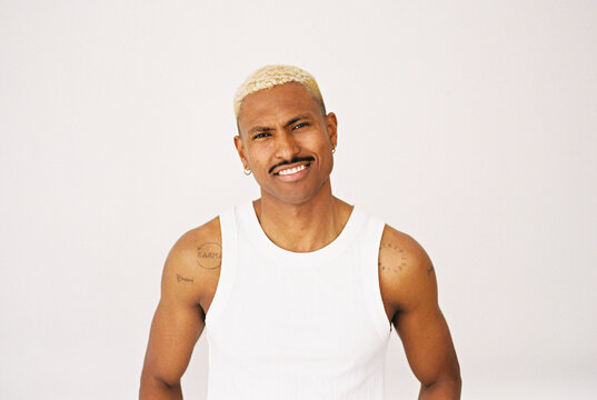 Man with blond hair and mustache smiling