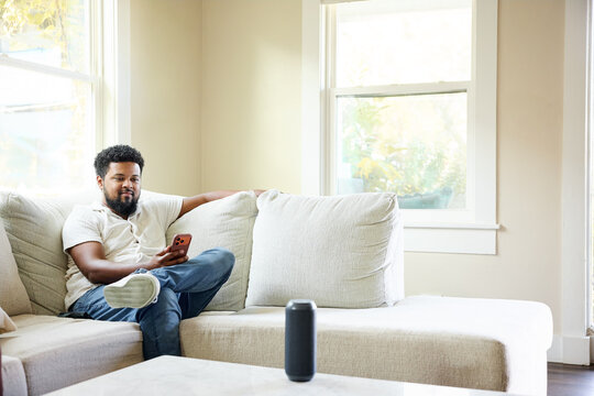 Man Using Smartphone in a Cozy Home