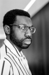 Fototapeta premium African american man looking over shoulder with glasses