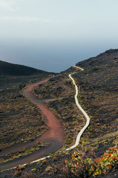 Winding volcanic trail and road on La Palma hillside