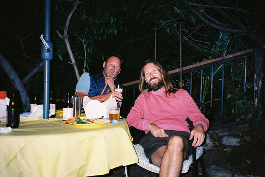 Friends enjoy their time at night in a relaxed setting.