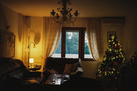 Cozy living room with Christmas tree and warm evening light