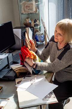Elderly woman designer working with palette of fabric samples
