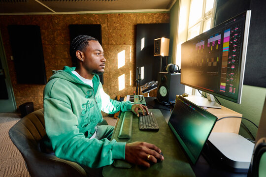 Black Music Producer Working in Professional Home Studio Environment